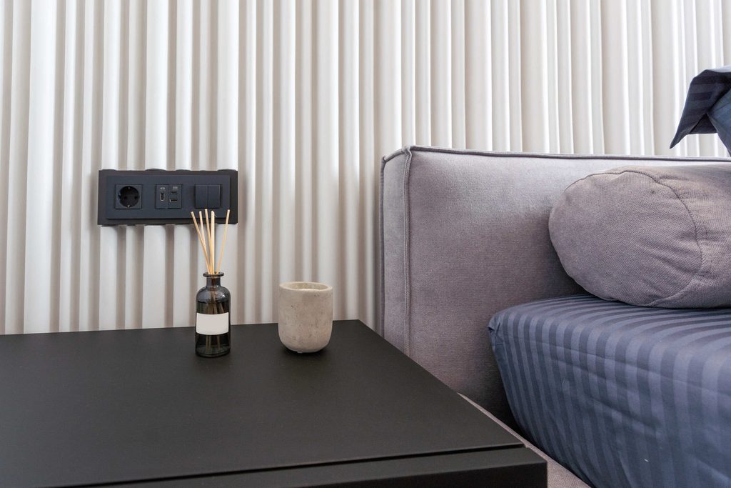 Bedside double socket planned on a double gang electrical junction box in a bedroom layout